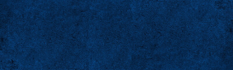 Navy blue rough wall wide panoramic texture.  Indigo color dramatic abstract textured background