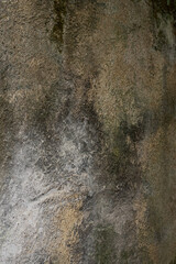 Old shabby stone wall with mould and stains