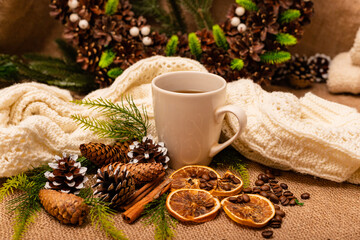 Obraz na płótnie Canvas Christmas composition spruce cones, cup, citrus, cinnamon on burlap