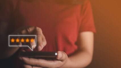 Customer touch smart phone on screen to review satisfaction feedback survey concept, User give rating to service experience on online application, Customer can evaluate quality of service leading.