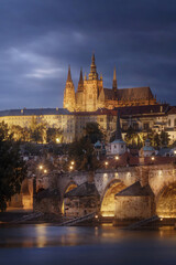 Prague Castle and Charles bridge with dramatic clouds at night, Czech Republic	
