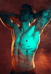 Beauty, fitness and man with smoke in studio with red lighting for workout motivation. Power,...