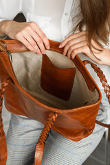 close-up photo of orange leather bag in a womans hands