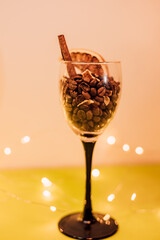 Coffee beans in a glass with cinnamon and dried orange