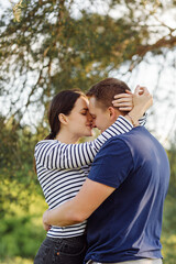Fototapeta premium A young couple in love walks in the woods, having a good time together