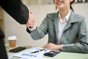 Two Asian businesswomen are shaking hands in the office. business cooperation