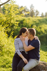 Fototapeta premium A young couple in love walks in the woods, having a good time together
