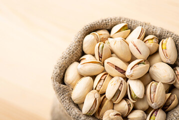 Macro shot of pistachios in linen bag. Close up of pistachios