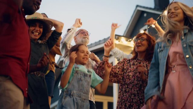 Portrait of a Senior Happy Couple Dancing Together with Children and Friends at a House Garden Party Event. Young and Elderly People Having Fun on a Warm Summer Evening. Slow Motion Footage.