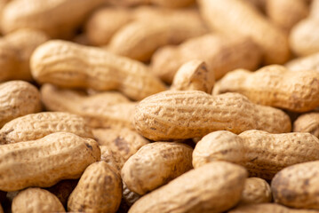Close up shot of peanuts. Unpeeled peanuts background