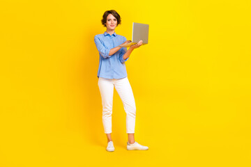 Full size photo of adorable gorgeous woman with bob hairdo dressed blue shirt hold laptop remote...