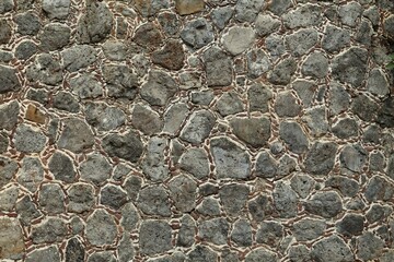 Texture of grey stone wall as background, closeup