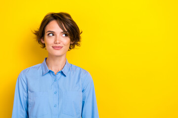 Closeup photo of young positive businesswoman wear formal blue shirt leader boss dreamy interested look empty space ad isolated on yellow color background