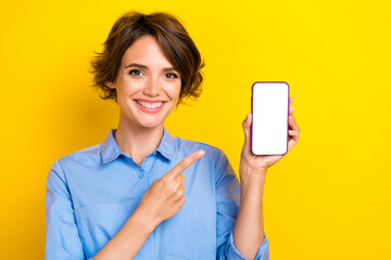 Photo of cheerful nice girl with brown hair dressed blue shirt directing at phone app advertising...