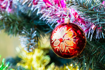 Close up of balls on christmas tree. Bokeh garlands in the background.