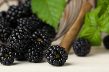 Fresh ripe blackberries on white wooden table, closeup