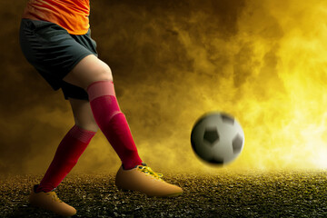 Football player man in a red jersey kicking the ball