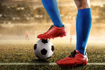 Football player man in a blue jersey standing with the ball