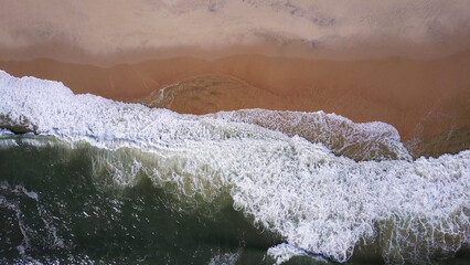 Naklejka na ściany i meble Ocean waves crashing on beach