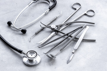 Dental or surgical steel instruments with stethoscope. Healthcare background