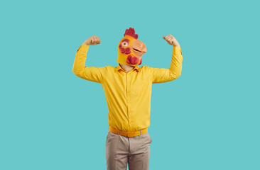Man in funny chicken disguise pretends to be strong and have superpower. Overconfident young guy...