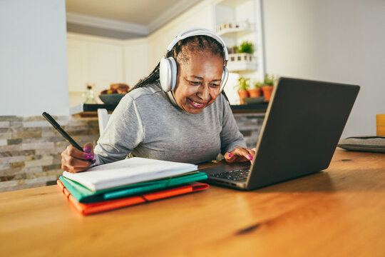 Senior woman working from home - Joyful elderly lifestyle, smart work and technology concept - Focus on face
