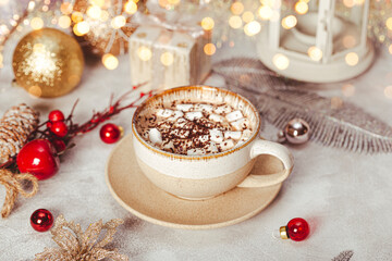 Obraz na płótnie Canvas A cup of cocoa with marshmallows on a New Year's table on a white background. Cozy Christmas card