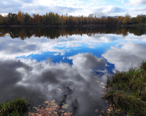 harmonious autumn landscape of clouds reflecion in water  