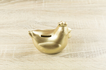 Golden chicken bank on the table, saving money for future , loan investment concept