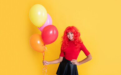 happy child with party balloon on yellow background