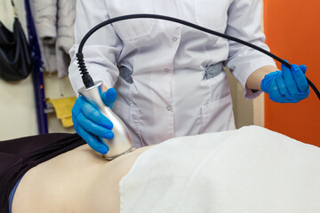 Anti-cellulite massage in the abdomen in a beauty parlor.