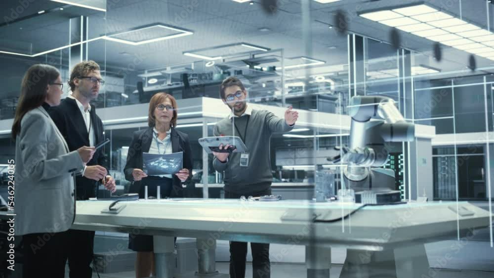 Aufkleber professional multicultural team of female and male engineers using industrial programmable robotic a