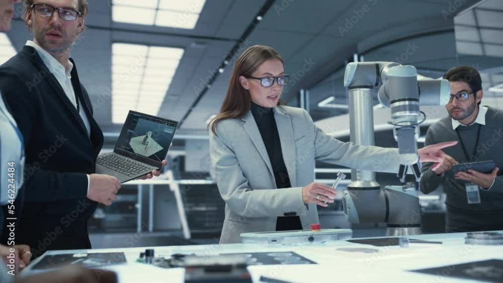 Poster Team Leader Working with Robotics Engineers on a Robot Arm Project, Discussing the Project in Scientific Technology Lab. Young Team Researching and Developing an AI Robotic Arm in Industrial Facility.