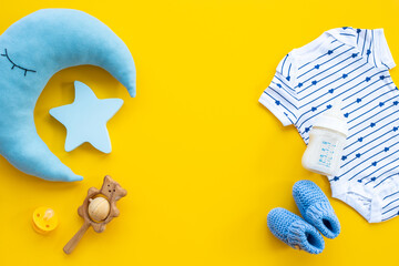 Baby cotton bodysuit with bottle of milk and toys