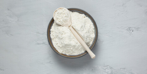 Flour in a plate on a gray backround
