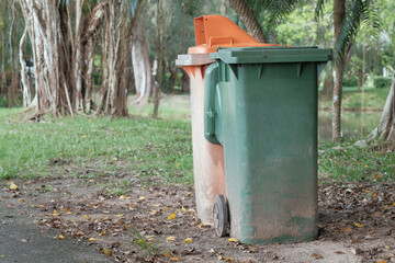 Old and weathered two recycle bin in public park area, copy space.