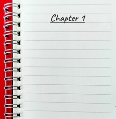 Red notebook with text written CHAPTER ONE, concept of author start writing book or novel, writers...