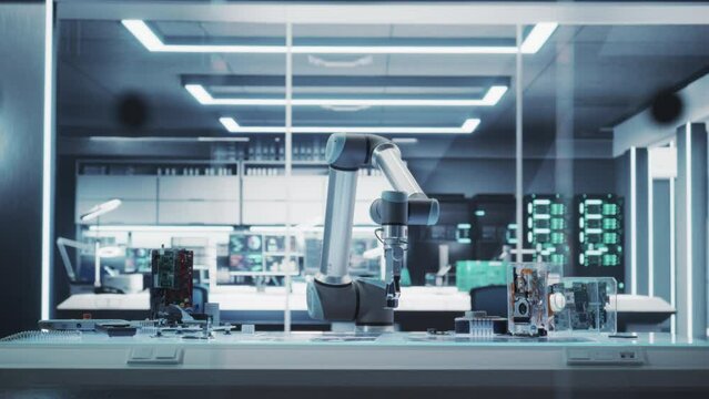 Establishing Shot: Modern High Tech Robotic Arm Picking Up and Moving a Microchip. Robot Hand Working at a Research and Development Factory with Server Racks in the Background. Static Footage.