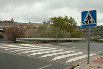 zebra crossing, sign of the same both vertical and horizontal on a road in the Community of Madrid. Black and white