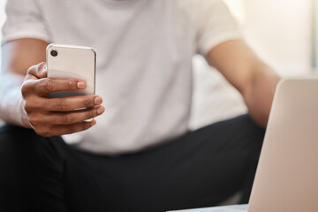 Phone, communication and hands networking on social media, surfing the internet or searching for online content. Laptop, website and man texting, reading an email or posting on a social network app