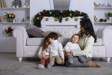 A young family with children decorates the house for the holiday. New Years Eve. Waiting for the new year.