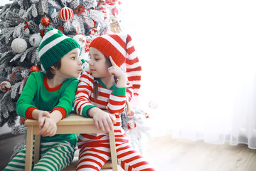 Santa Claus sitting with little cute elves over Christmas background. Time of miracles. Gifts from Santa Claus.