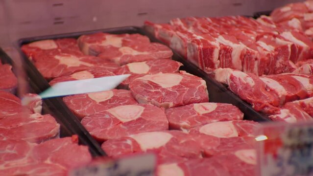 Raw beef meat osso buco shank steak lower part of cows foreleg. Red meat selection in butchers shop, fresh beef osso.