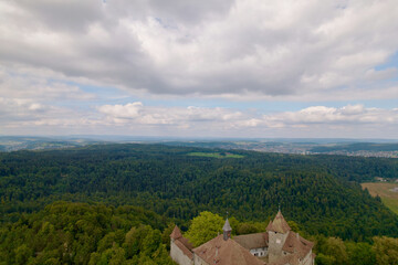 Fototapeta premium Aerial view of medieval village Kyburg with famous castle on a cloudy late summer day. Photo taken September 1st, 2022, Kyburg, Switzerland.