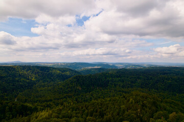 Naklejka premium Aerial view of woodland seen from medieval village Kyburg on a cloudy late summer day. Photo taken September 1st, 2022, Kyburg, Switzerland.