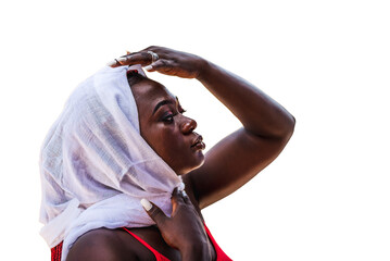 African woman styles herself up with a white headdress covering her hair