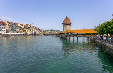 LUCERNE, SWITZERLAND, JUNE 21, 2022 - View of the wodden covered Kapellbr&uuml;cke Bridge on the Reuss river in Lucerne, Switzerland