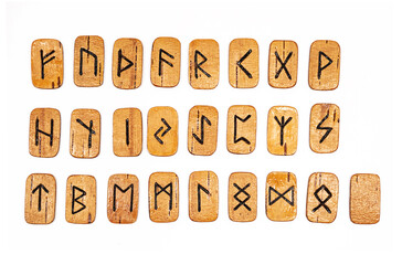 Handmade wooden runes on white. Set of Scandinavian runes for divination.