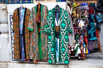 Fototapeta premium Uzbek traditional clothes such as robes and other colorful souvenirs, Tashkent, Uzbekistan. 