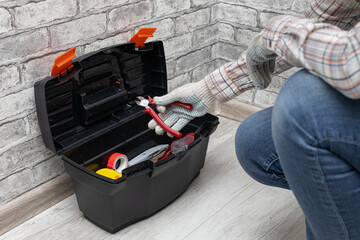 a man takes out a tool from a toolbox